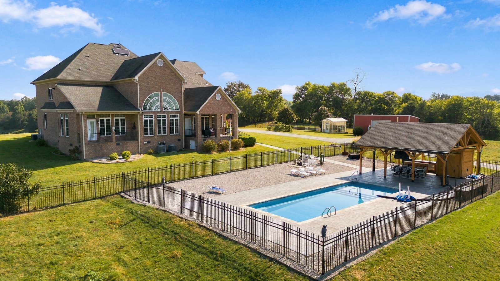 The rear of the residence opening to the pool and the view