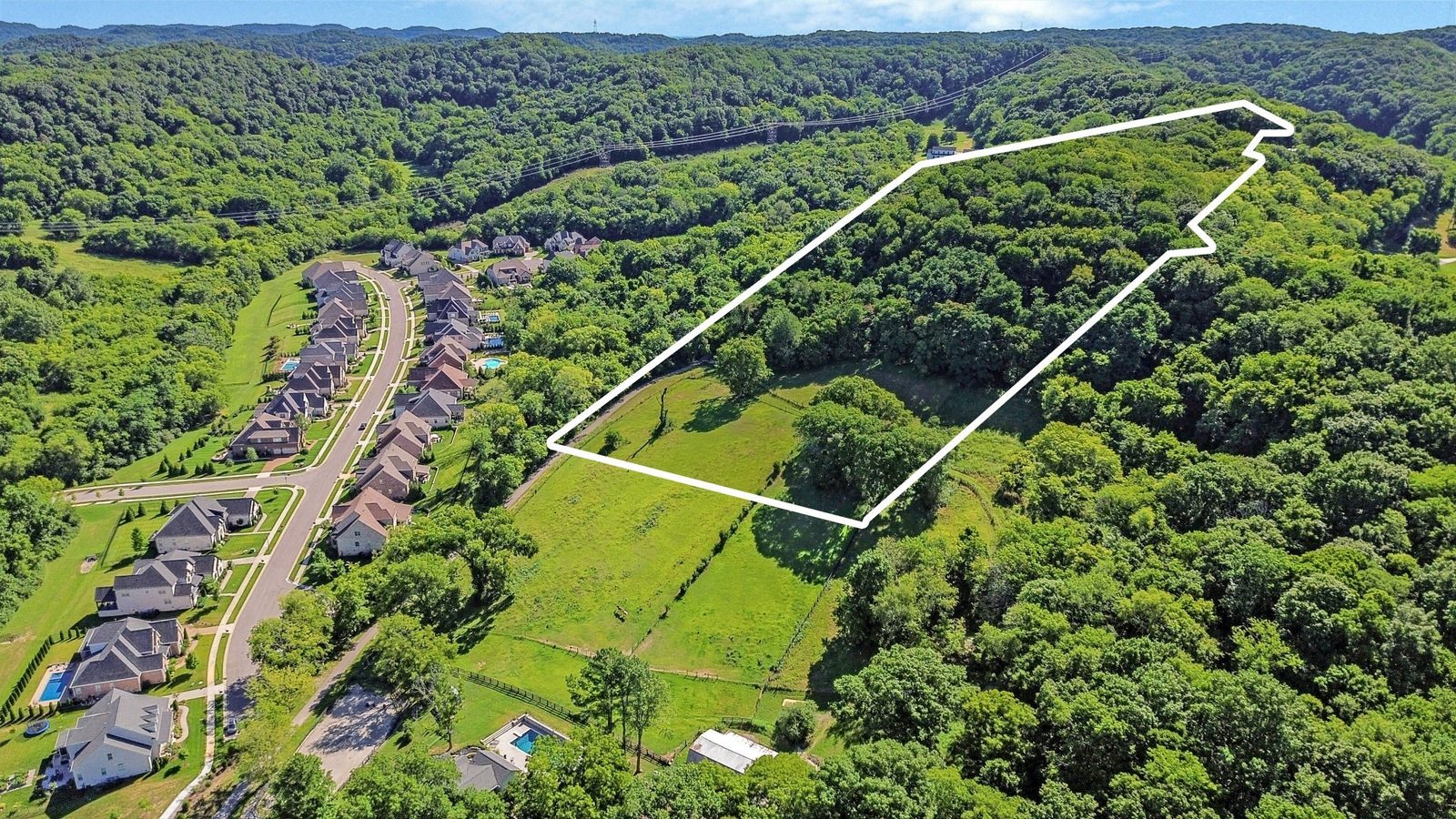 Aerial showing the 15 acre parcel outlined beside an established Franklin neighborhood