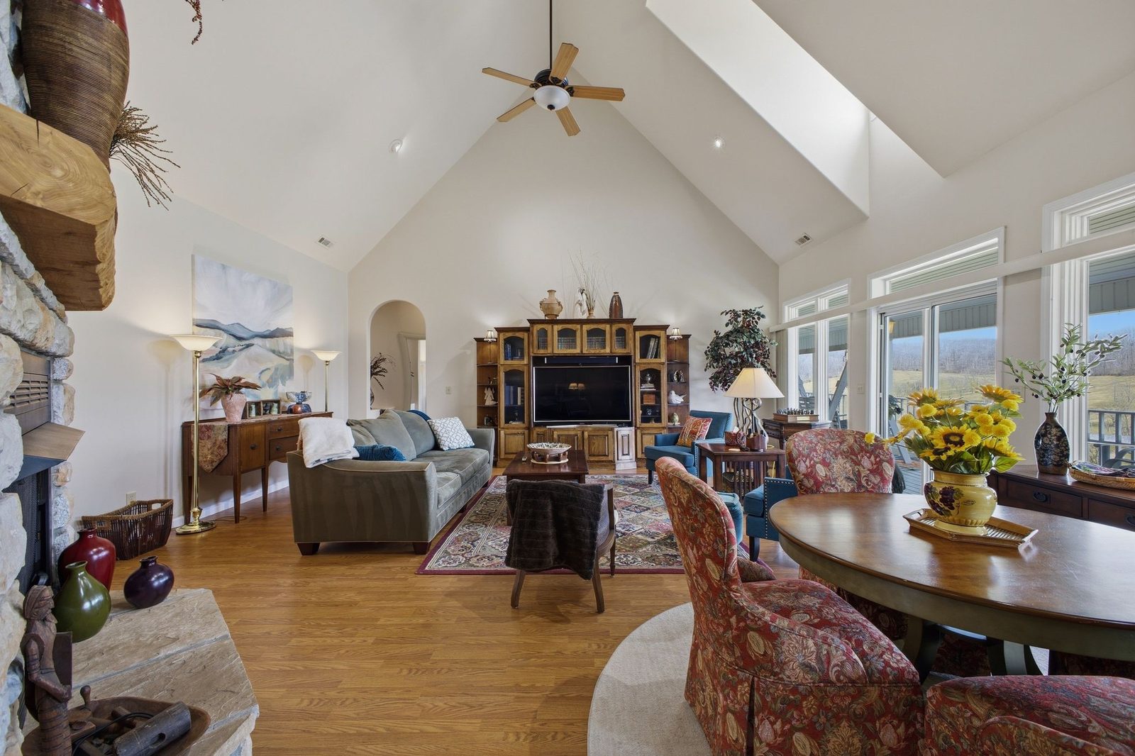 Great room with soaring ceilings and a stone fireplace
