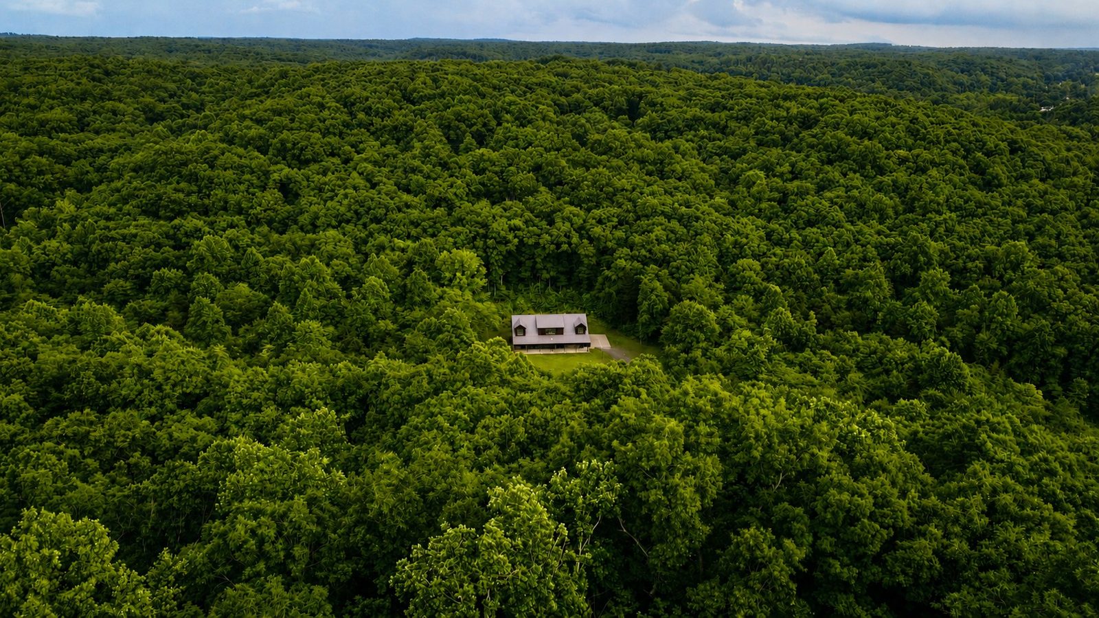 A barndominium tucked into a clearing within 240 acres of Hickman County forest
